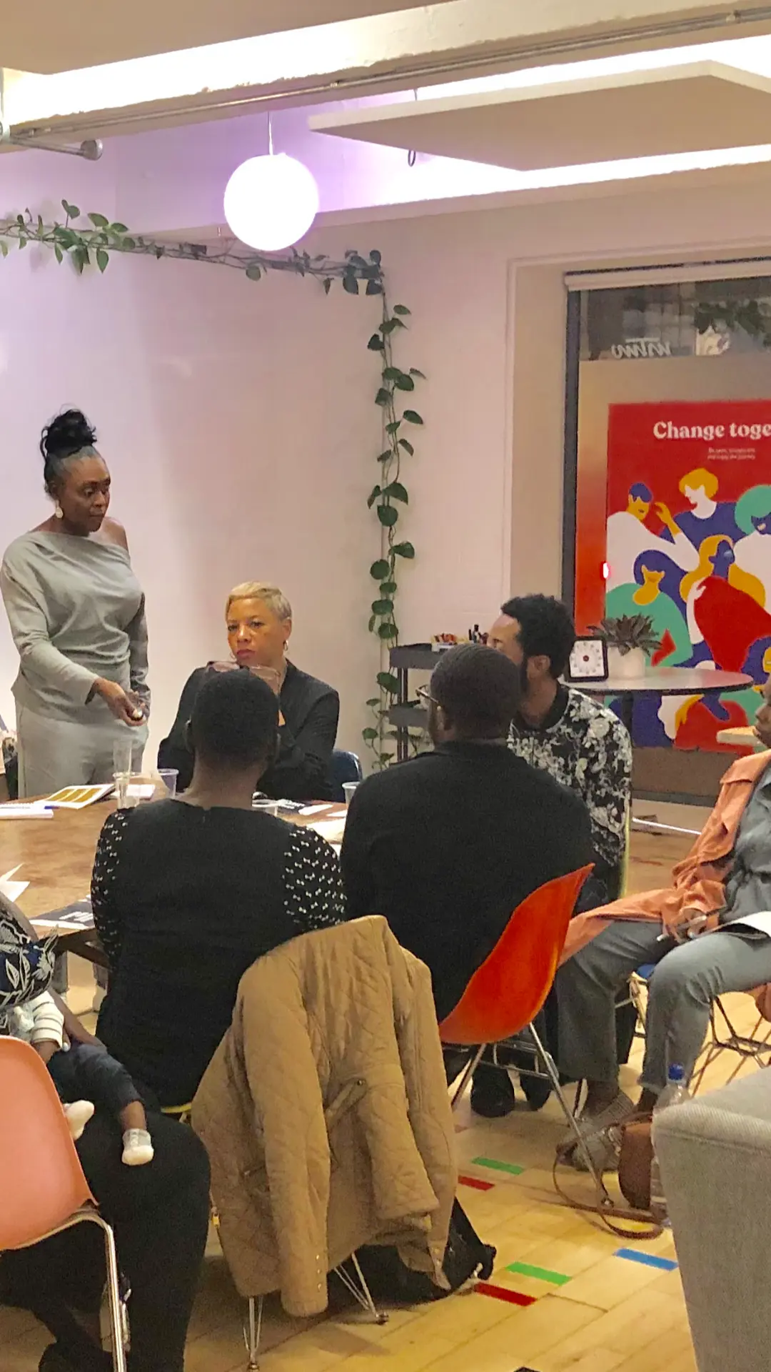 Karen Thorpe-Reid leading a group session with a team around a table