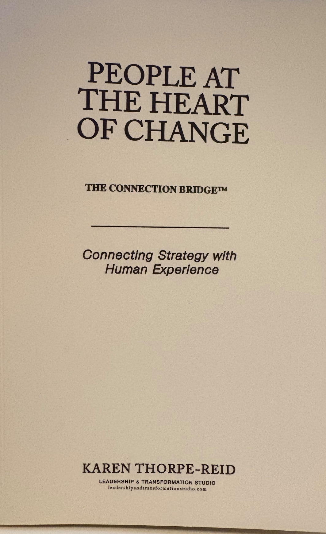 The first printed edition of People at the Heart of Change — cream cover with the Connection Bridge subtitle, by Karen Thorpe-Reid